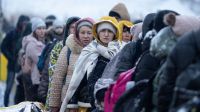 Refugees fleeing armed conflict in Ukraine arrive at the Polish border.