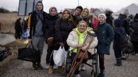 Medyka, Poland. Alla (in the wheelchair) and her family arrive at Medyka after crossing the border from Ukraine to Poland.