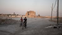 Two children play in the ruins of Mosul, Iraq